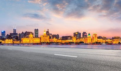 Shanghai city skyline and empty asphalt highway at sunset