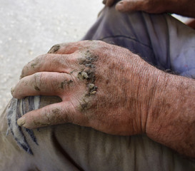 Strong dirty hands of a countryside rural area plumber. Concept of successful hard-working person who provides future for his children.