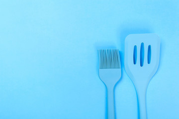 different kitchenware on a blue background top view. Cooking appliances.