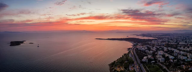 Poster Panoramic aerial view of the Athens Riviera coast with beaches and restaurants during sunset time, Greece © moofushi