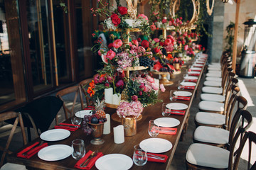 Wedding table flowers with fruits and berries decor in red white pink green colors.