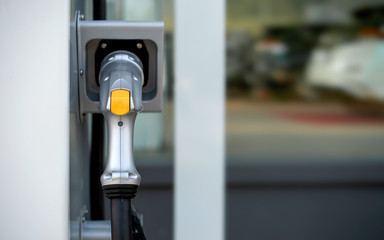 closeup charger battery for electric car with soft-focus and over light in the background