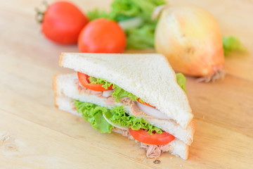 sandwich tuna salad with the ingredients on wood plate