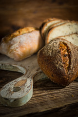 Homemade healthy whole grain bread on rustic wooden background