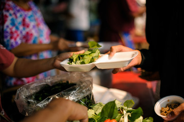 Poor people receive donated food from donors: The hands of the poor receive food from the hands of the humane : the concept of relief