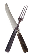 Beautiful old vintage crossed knife and fork isolated on white background. Top view. Retro silverware.