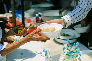 The concept of feeding : The hands of the poor receive food from the hands of the humane : Helping Feed the Poor