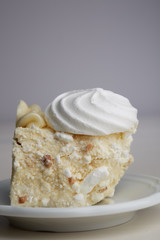 Piece of cake with meringue and nuts on a plate