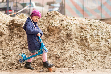 child with a scooter on his shoulder