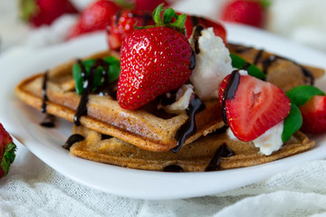 Belgium waffles dessert with strawberries, ricotta cheese and chocolate. Selective focus.