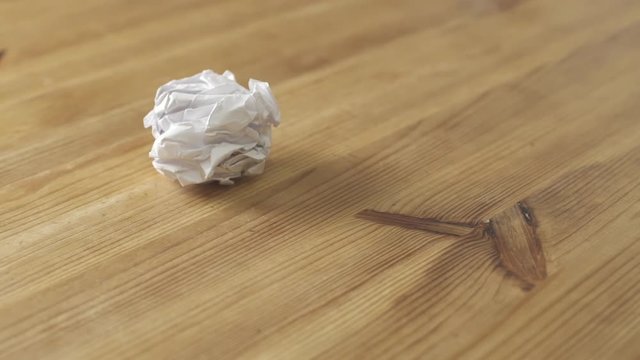 Crumpled papers are thrown on wooden table
