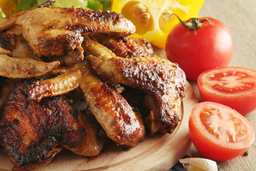 Chicken wings barbecue with different vegetables	