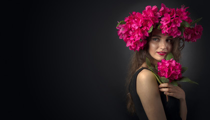 Naklejka premium Portrait of attractive young woman with long curly hair and wreath on a head.