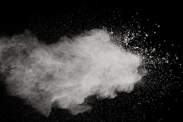 Naklejka premium White powder explosion.Freeze motion of white dust particles on black background.