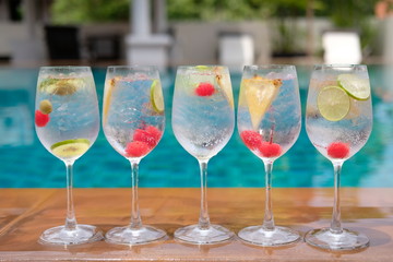 Summer drinks gin tonic in wine glasses at poolside bar