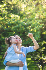 Divorced Mother Holding her Daughter Outdoors.