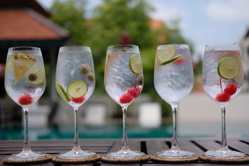 gin and tonic in wine glass at pool bar
