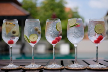 gin and tonic in wine glass at pool bar