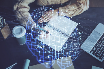 Multi exposure of writing hand on background with brain hologram. Concept of learning.