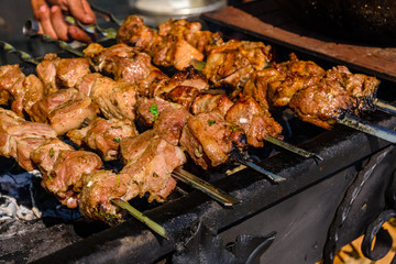 Skewers with meat over the charcoals. Cooking shashlik