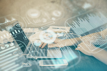 Technology theme hologram with man working on computer on background. High tech concept. Double exposure.