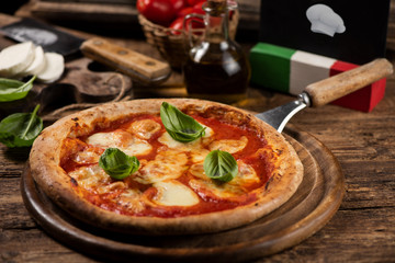 Italian pizza Margherita on a wooden table
