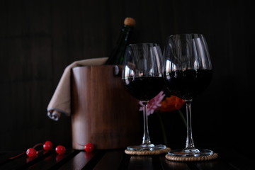 Close up wine glasses and bottles on wooden background