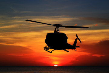 silhouette  the helicopter on sunset © rathchapon