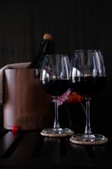Close up wine glasses and bottles on wooden background