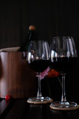 Close up wine glasses and bottles on wooden background