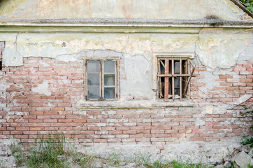 Fototapeta na wymiar The windows of abandoned dilapidated house