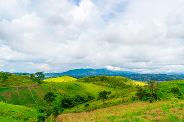 Blue sky high peak mountains fog hills mist scenery national park views at Phu Tub Berk, Khao Koh, Phetchabun Province, Thailand