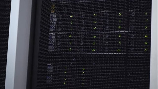 Blade server in rack cluster hard drives storage in internet data center room. Blink led.