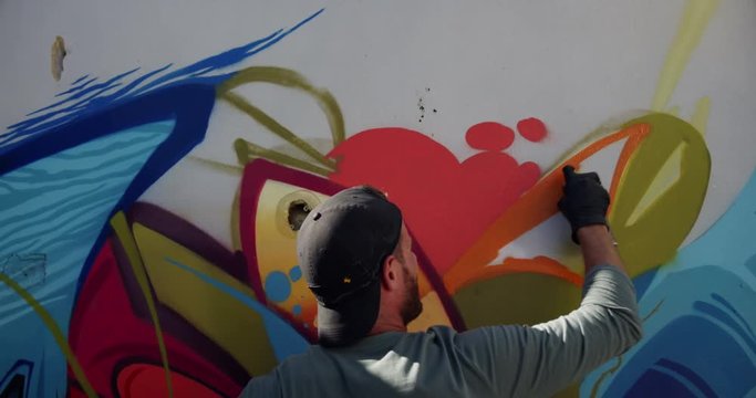 Graffiti artist painting with aerosol spray 4k