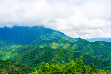 Obraz premium Blue sky high peak mountains fog hills mist scenery national park views at Phu Tub Berk, Khao Koh, Phetchabun Province, Thailand