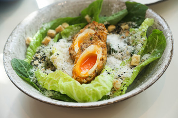 Caesar salad with Scottish egg