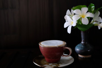 coffee cup with fresh milk on wooden table