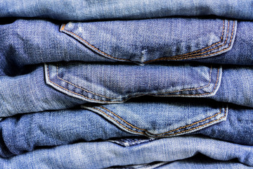 Stack of blue jeans background texture. Beauty and fashion clothing concept
