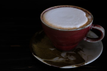 coffee cup with fresh milk on wooden table