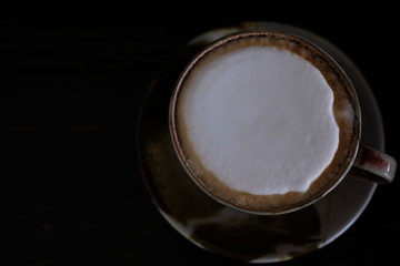 coffee cup with fresh milk on wooden table