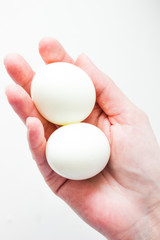 Fototapeta na wymiar Eggs in hand isolated on white background. Egg close up on a white background. White chicken eggs on a white background.