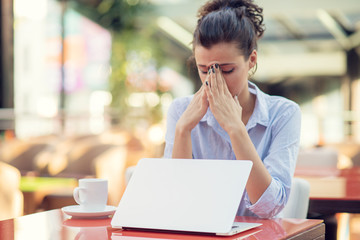 Young woman stressful, headache migraine, hand touch head feeling pain.