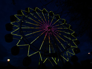 Amusement park ride on a ferris wheel at night. Lights on the ferris wheel.