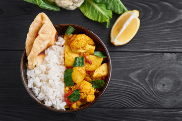 aloo gobi with rice and chapati. Indian cuisine vegetarian curry cooked with cauliflower, potato, ginger, garlic and spices - cumin, coriander, chili and garam masala. Copy space