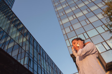 Fototapeta premium business, communication, technology and people concept - young smiling african american businesswoman calling on smartphone in city