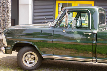 The front of a green vintage pickup truck © photosis