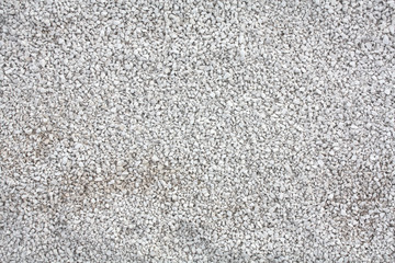 Background texture with small gray rocks.