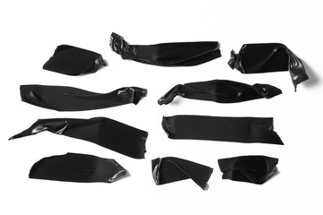 Set of black tapes on white background. Torn horizontal and different size black sticky tape, adhesive pieces.