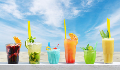 Fresh cold drinks on the beach background