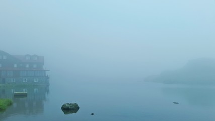 Fototapeta premium mountains fog darkness top travel tourism lake edge of light landscape background sunset sunrise